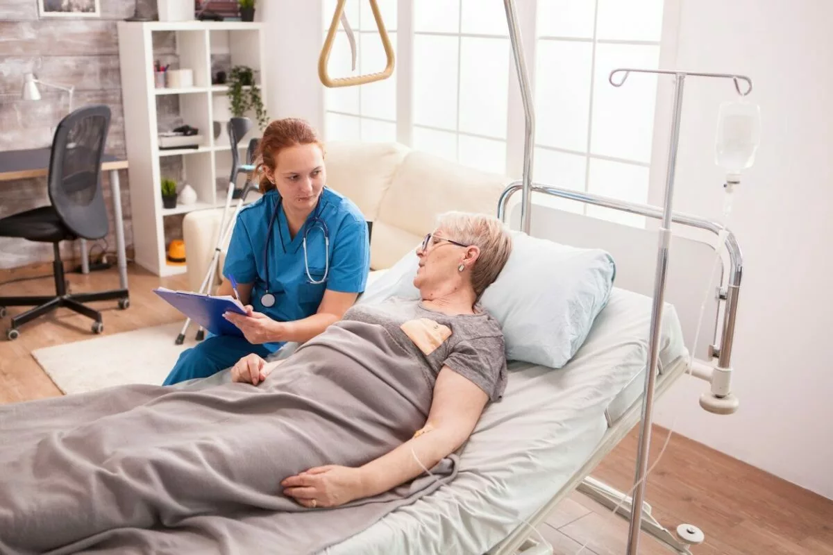 Senior woman lying in nursing home bed.jpg